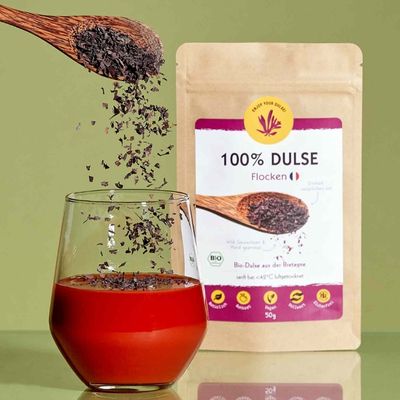 Bio Dulse Flocken 50g von Algenmarkt werden in ein Glas Tomatensaft gestreut
